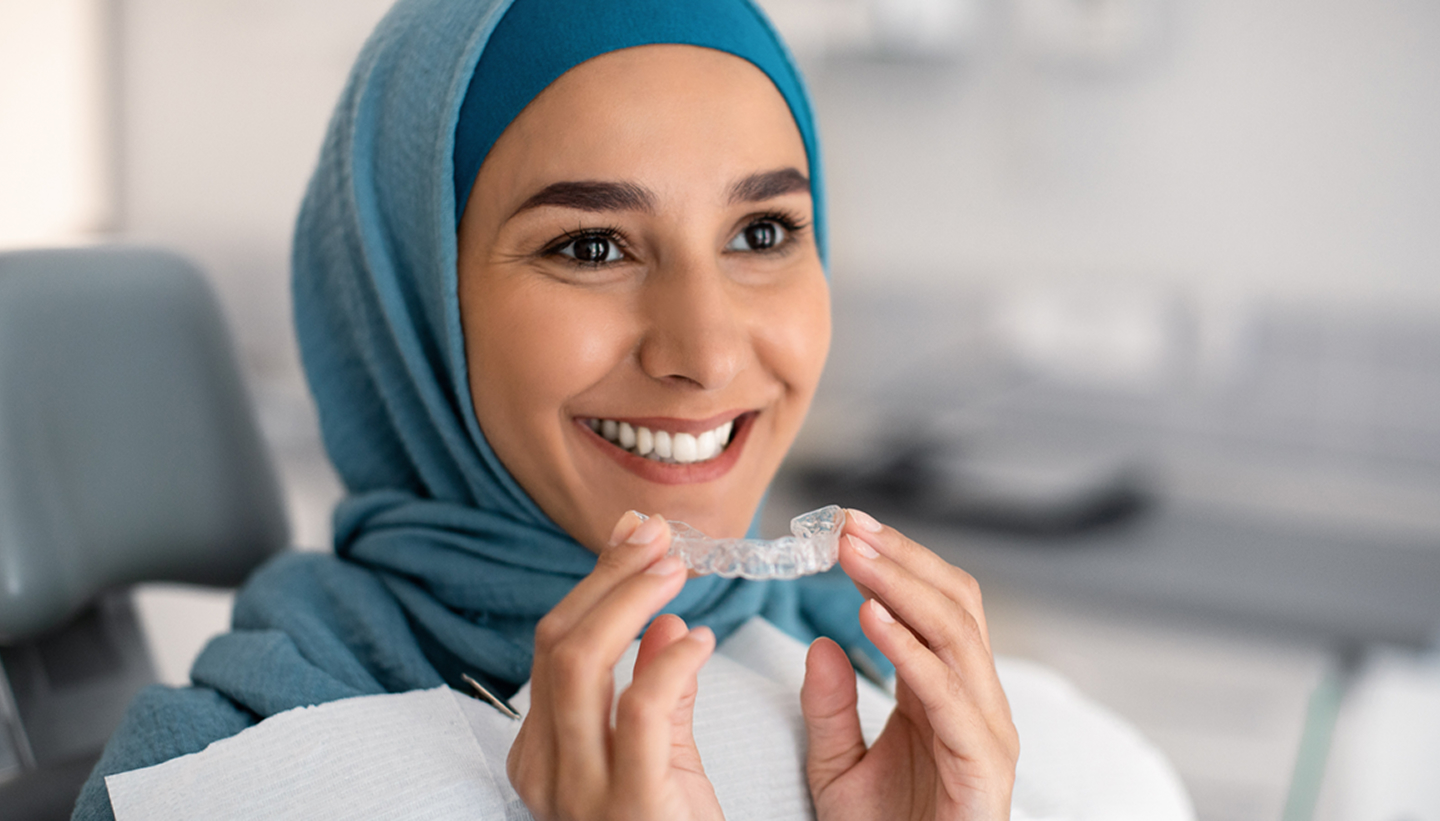Smiling woman with aligner